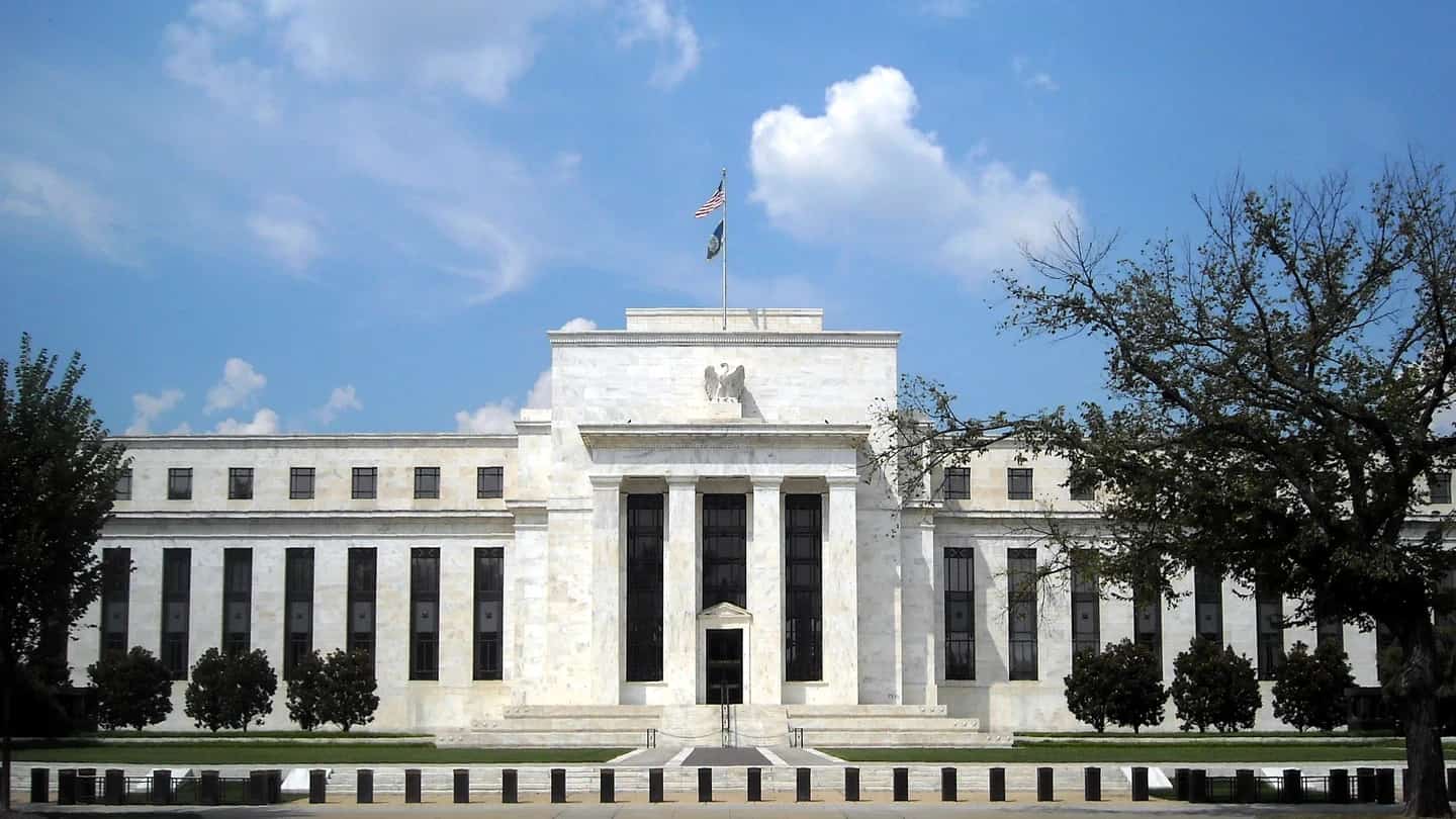 Prédio do Federal Reserve, o Eccles Building, em Washington, com a bandeira dos Estados Unidos no topo.