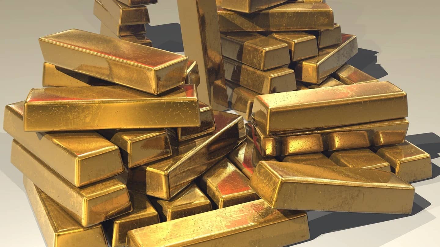 Barras de ouro empilhadas, uma das classes de ativos que lastreiam as reservas da stablecoin USDT