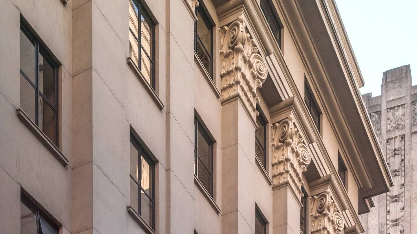 Fachada de pedra do antigo edifício da bolsa de valores de São Paulo, com janelas e capitéis esculpidos